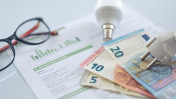 Facture d'énergie avec billets en euros et ampoule, illustrant le chèque énergie 2026